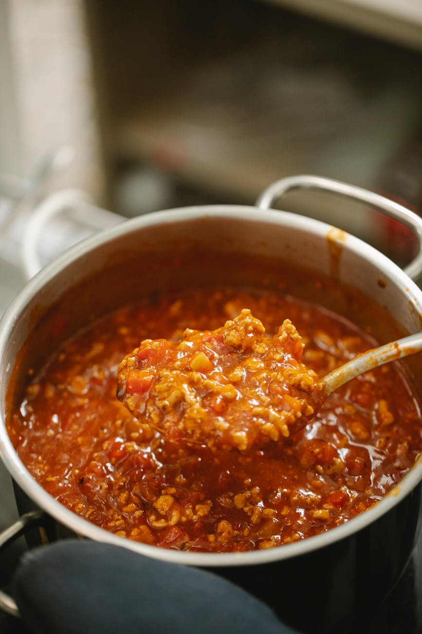 saucepan with delicious bolognese sauce on stove